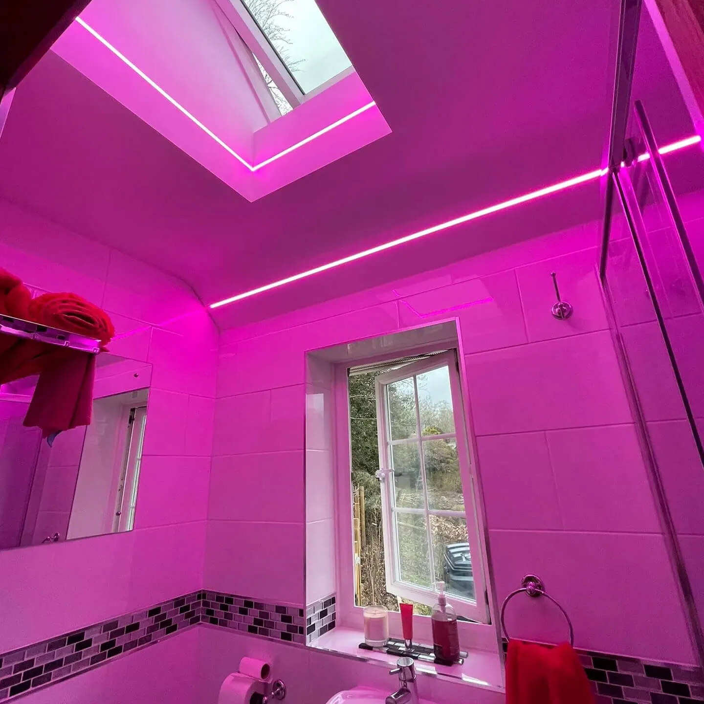 bathroom with pink lights on